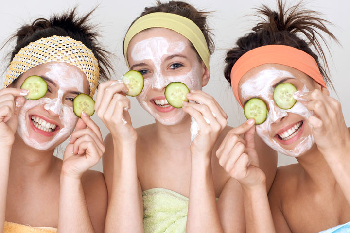 Three women with face masks and cucumbers on their faces.