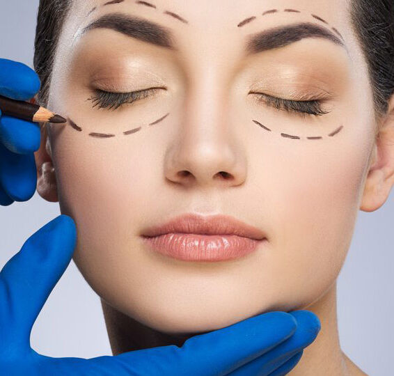 A woman getting her face waxed by an esthetician.