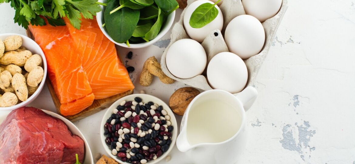 A white table topped with eggs next to nuts and other foods.