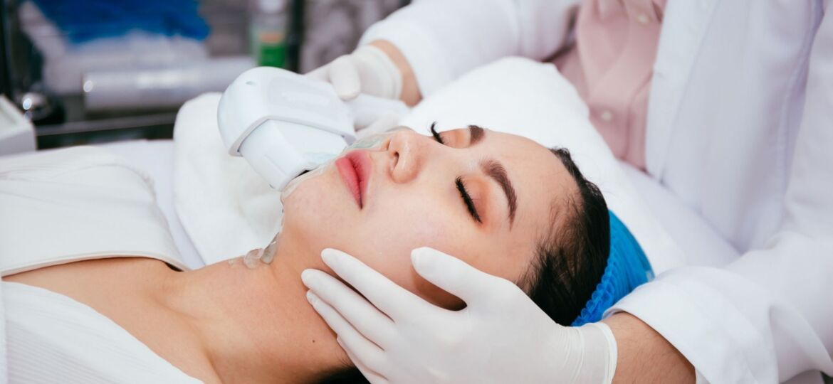 A woman getting her face waxed at the spa